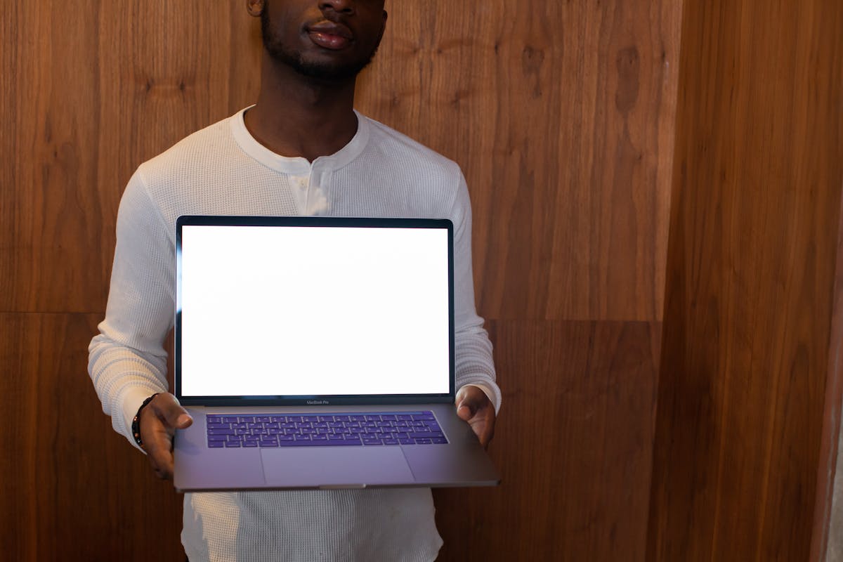 a man holding a laptop