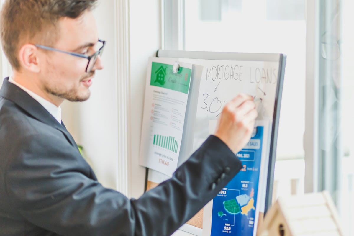 a man writing on the white board