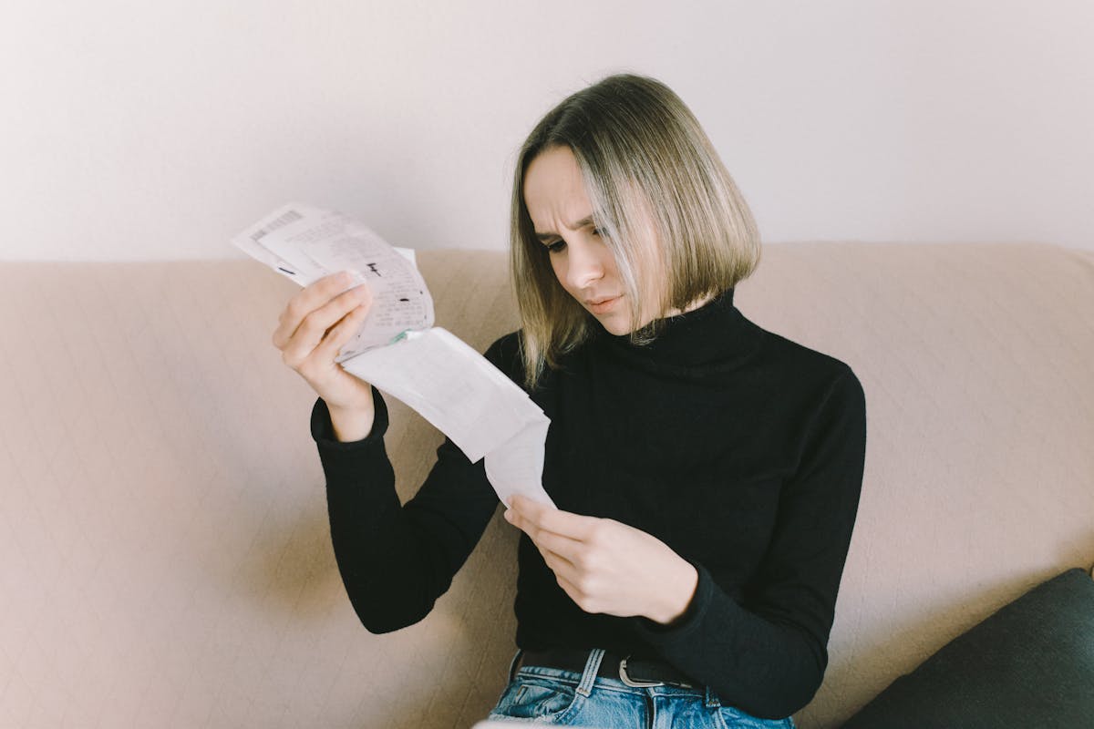 a woman in black long sleeve shirt holding white printer paper