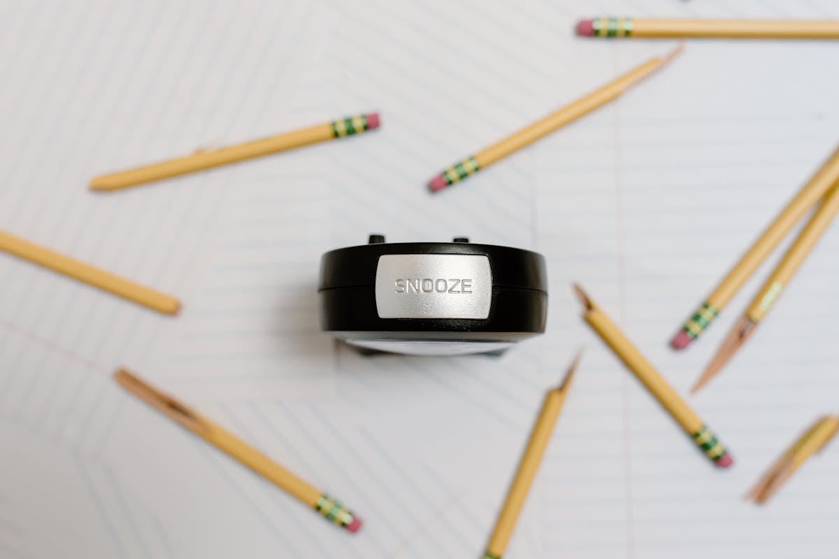alarm clock and pencils on white background alarm clock and pencils on white background
