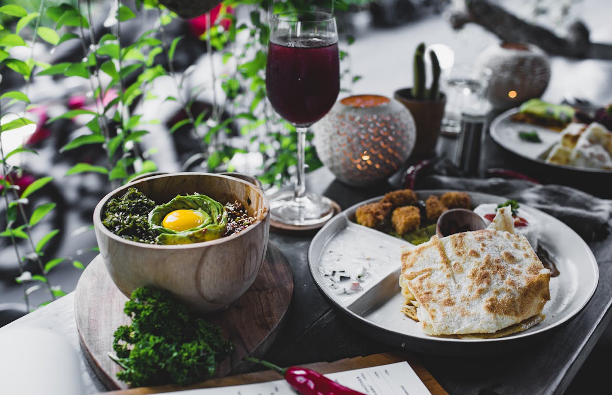 appetizing assorted asian dishes served on table with glass of cold drink