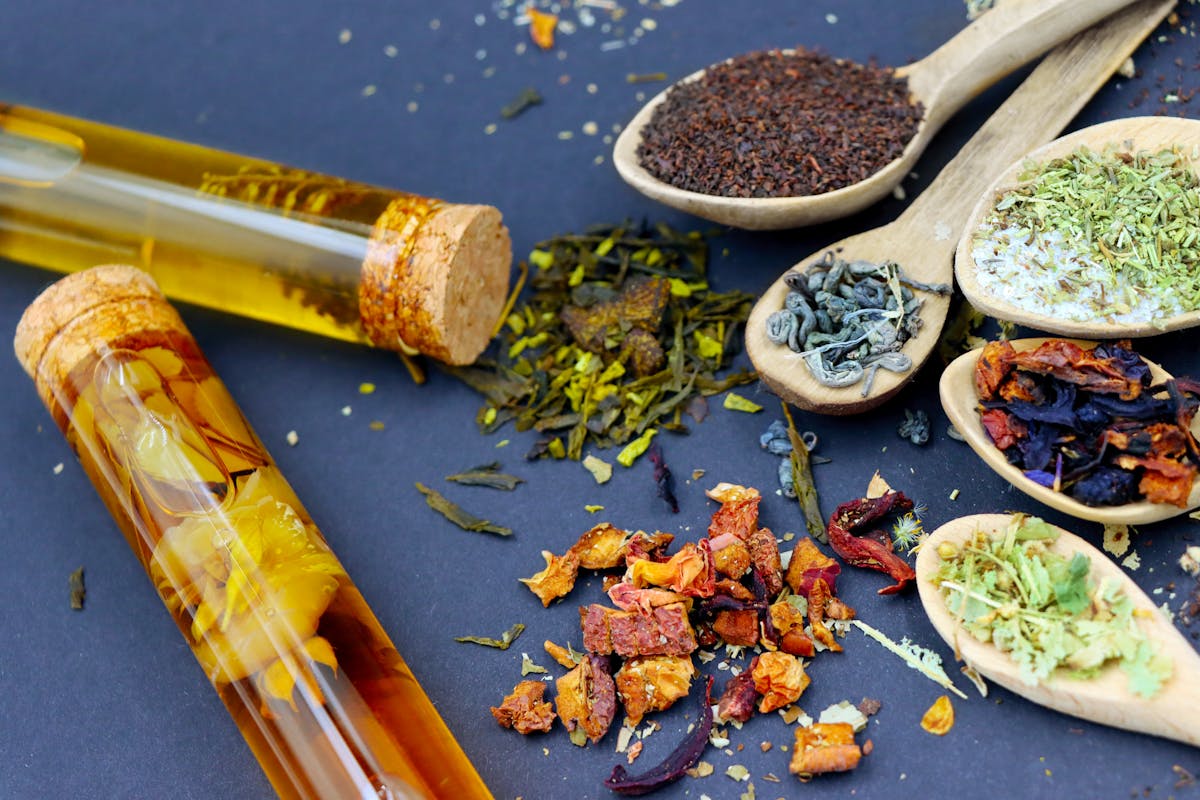 assorted herbal teas and spices in wooden spoons assorted herbal teas and spices in wooden spoons
