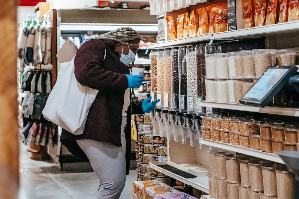 black woman choosing grains in supermarket