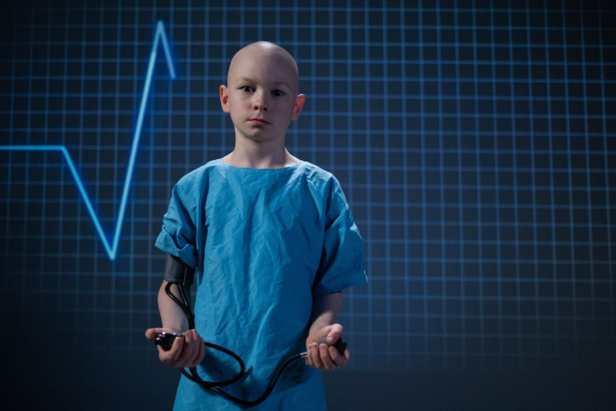 child wearing a blue hospital gown