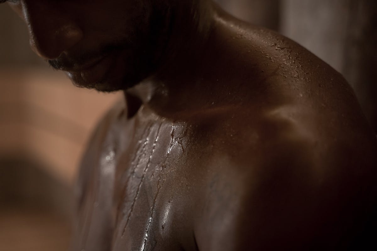 close up of a shirtless man with wet skin