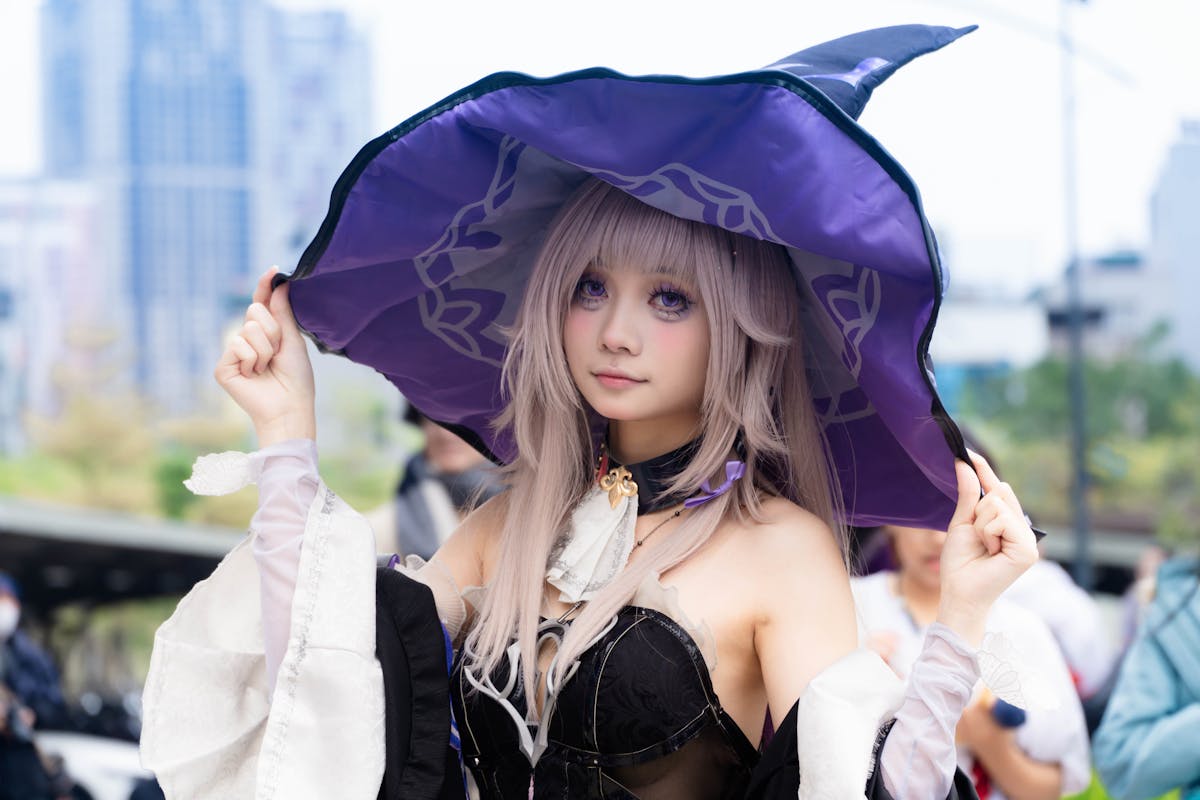 cosplayer in witch costume at outdoor event
