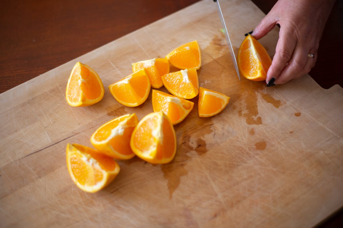 cutting oranges on tray