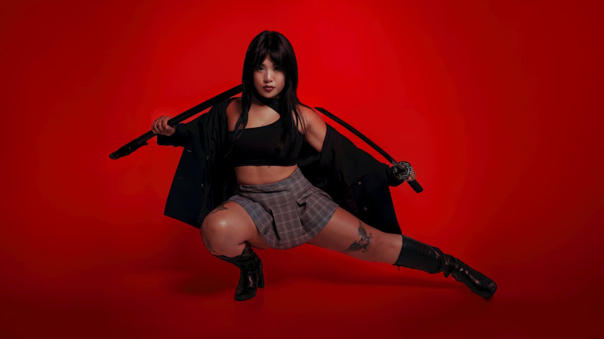 dynamic portrait of woman with sword on red background