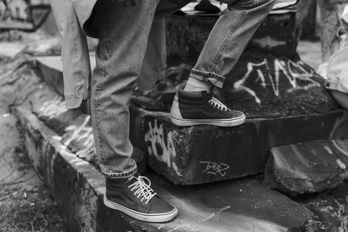 grayscale photo of a person wearing denim jeans