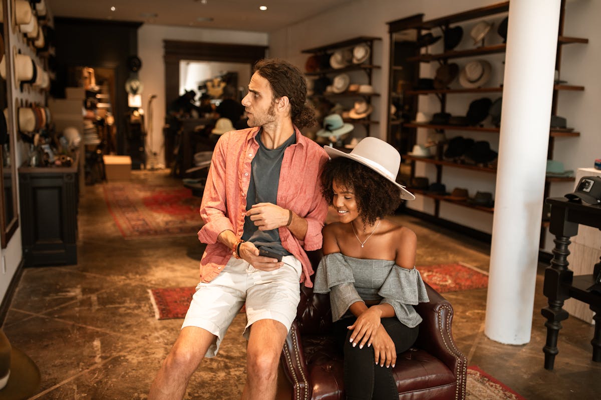 man in red jacket sitting on brown leather armchair