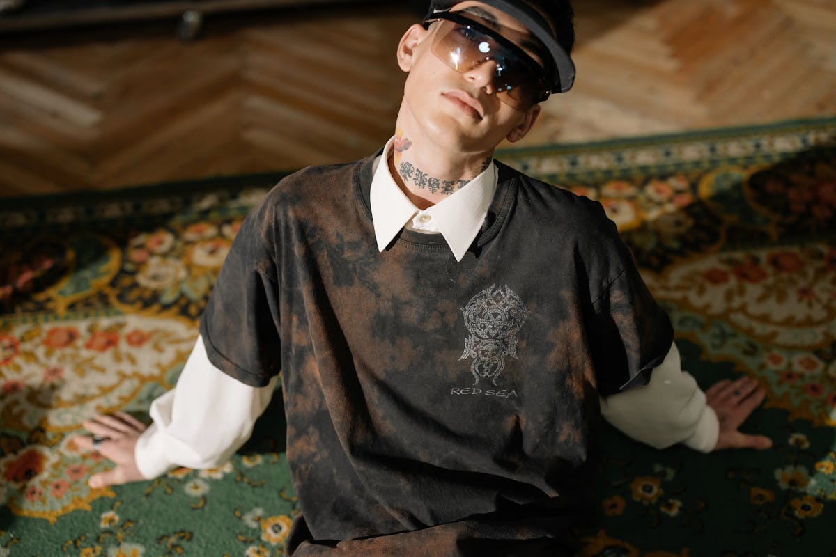 man in stylish outfit sitting on the carpet man in stylish outfit sitting on the carpet