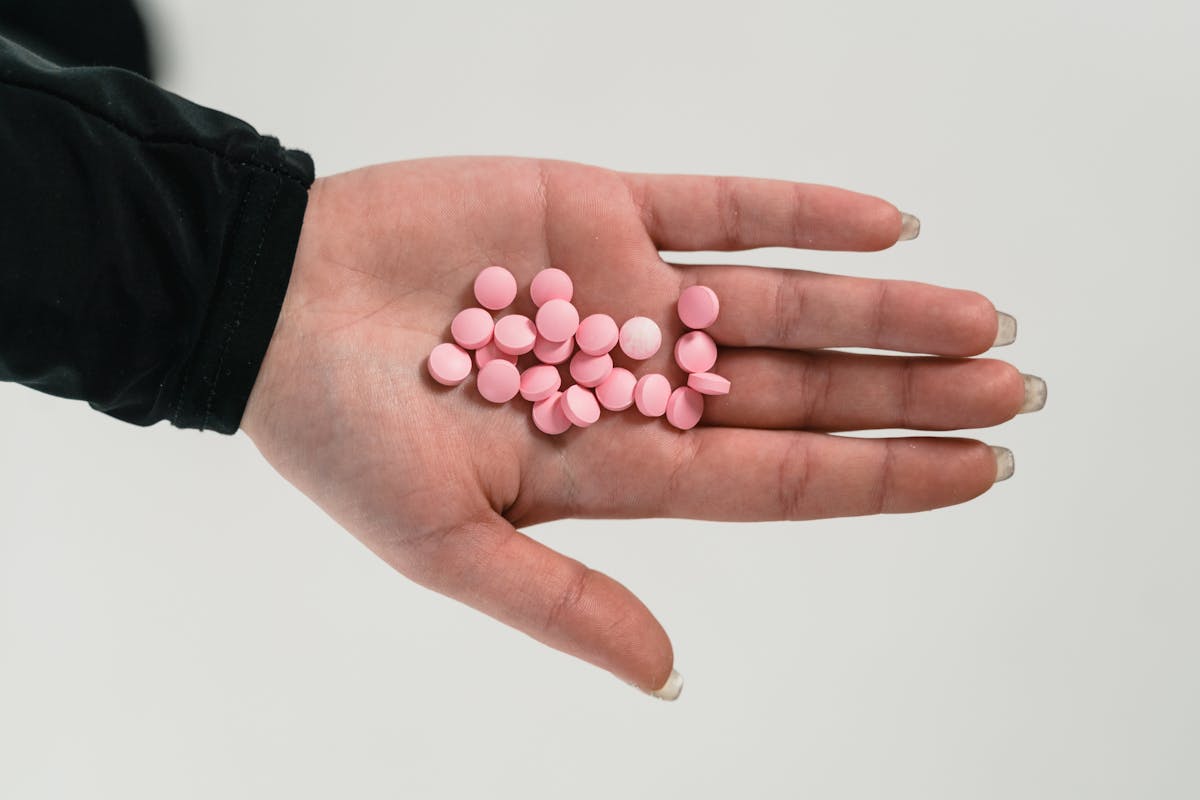medicine tablets on a person palm