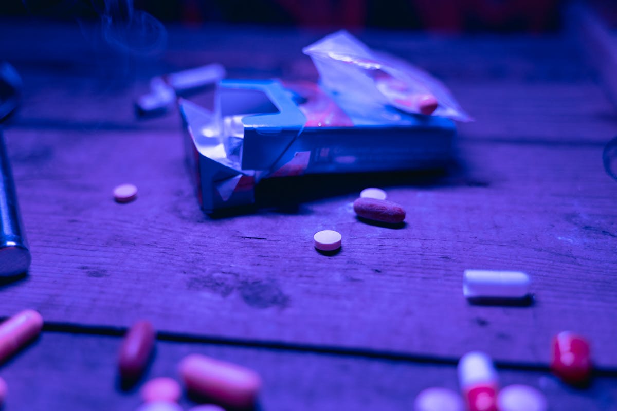 pink and white medication pill on purple box