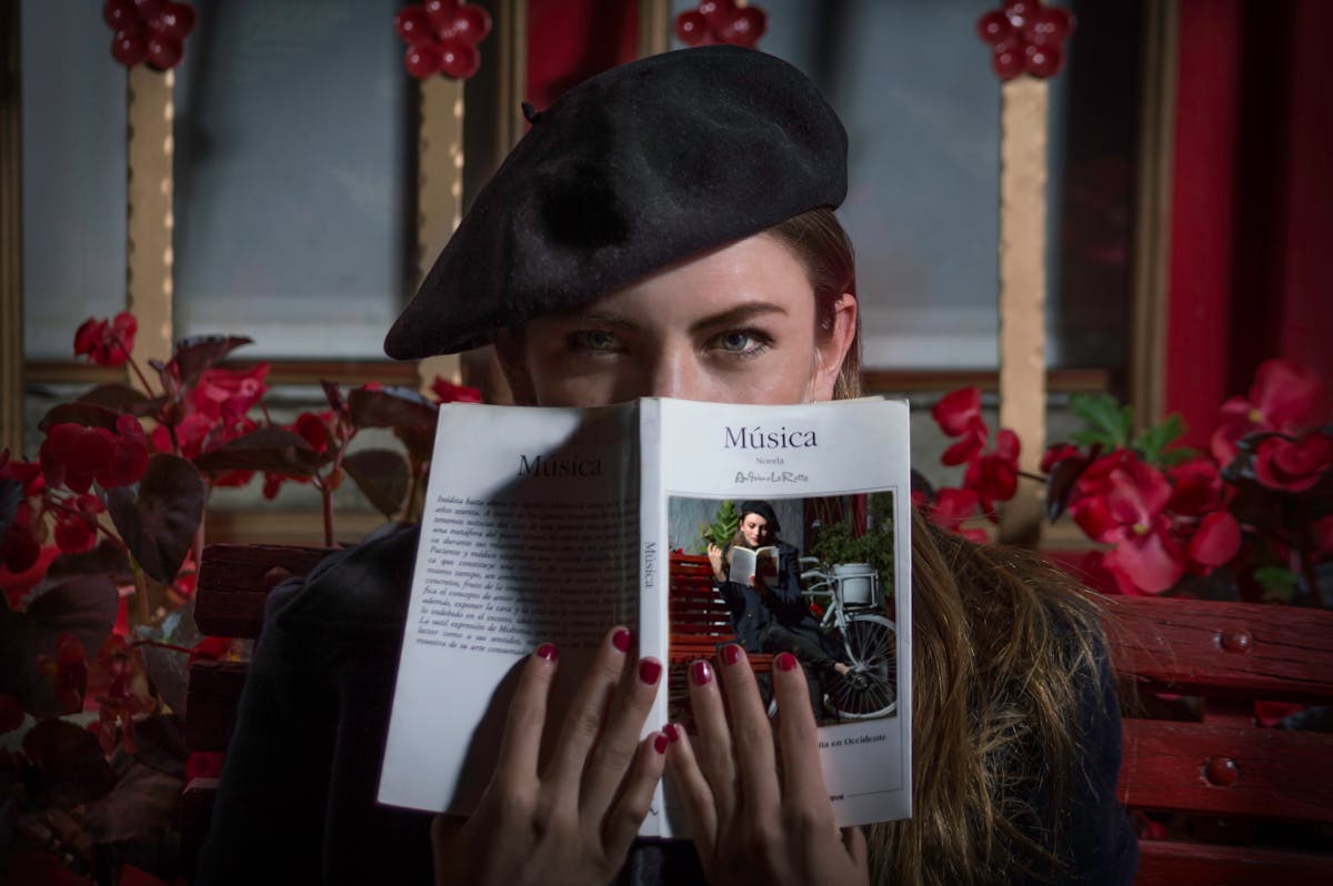 portrait of woman in beret holding book