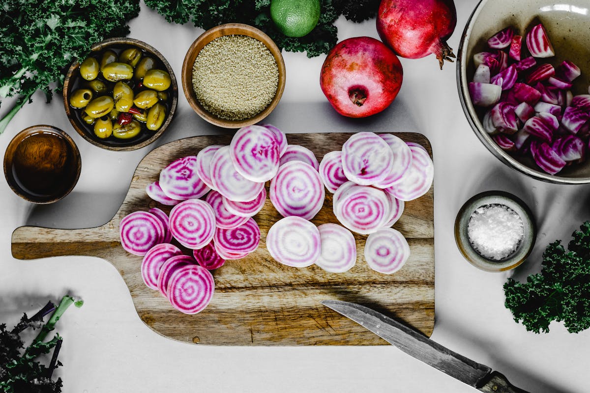 sliced vegetables on a wooden chopping board sliced vegetables on a wooden chopping board