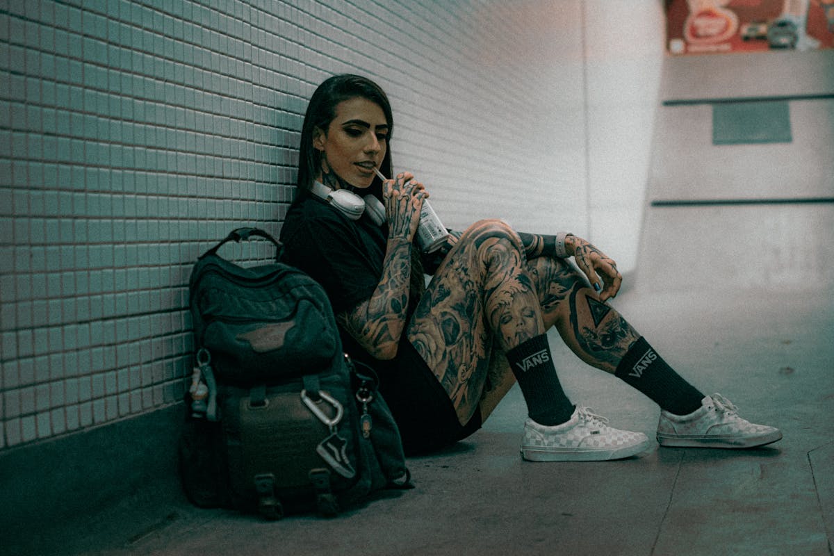 tattooed woman relaxing in urban setting