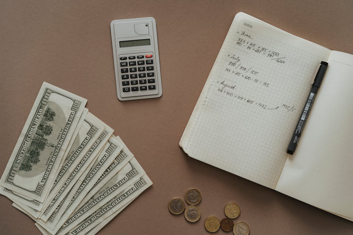 top view photo of notebook near money