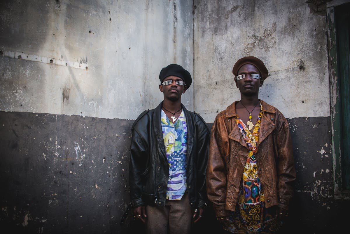 two people stand in front of a wall