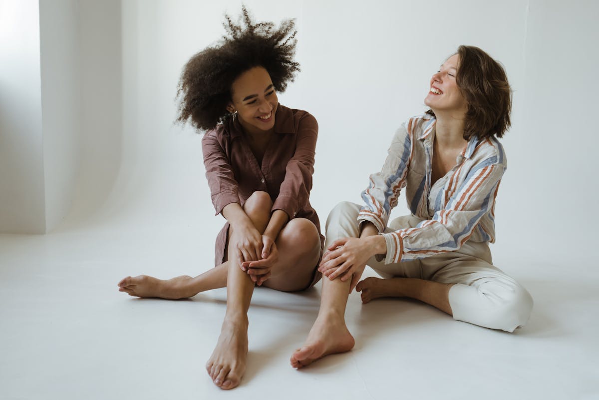 two women sitting on the floor two women sitting on the floor