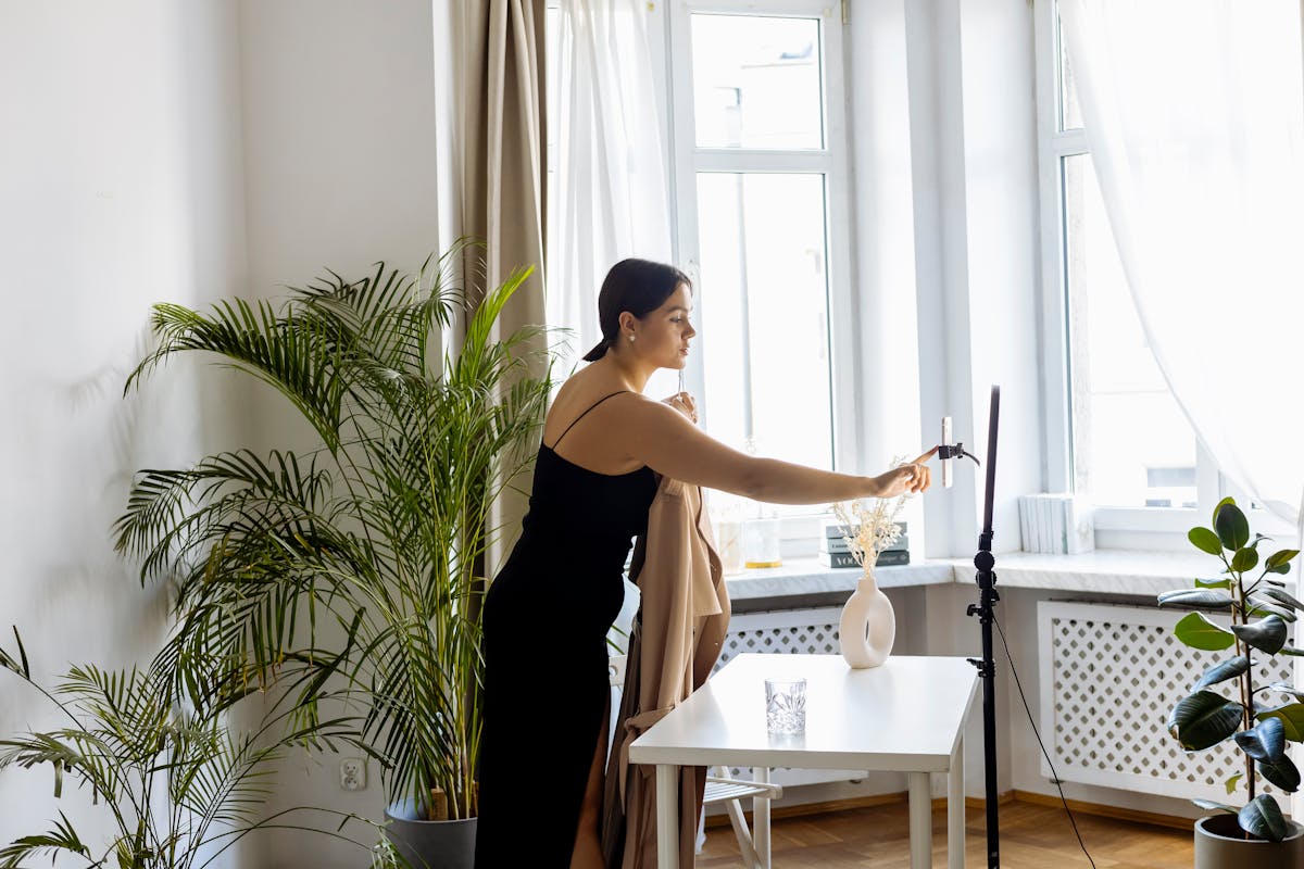 woman in black dress standing beside white table