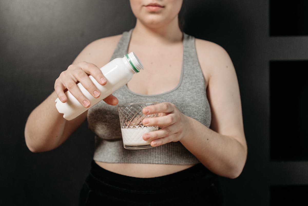 woman pouring a milk in the glass