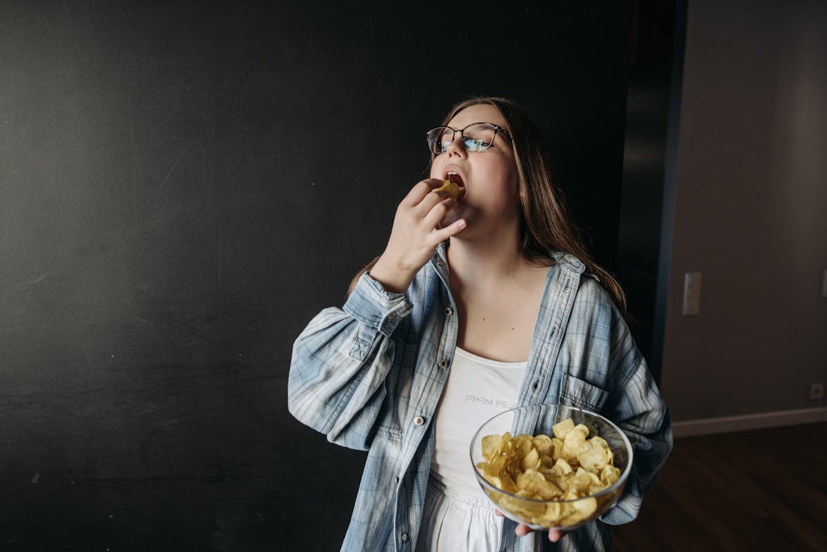 woman standing with a bowl of chips