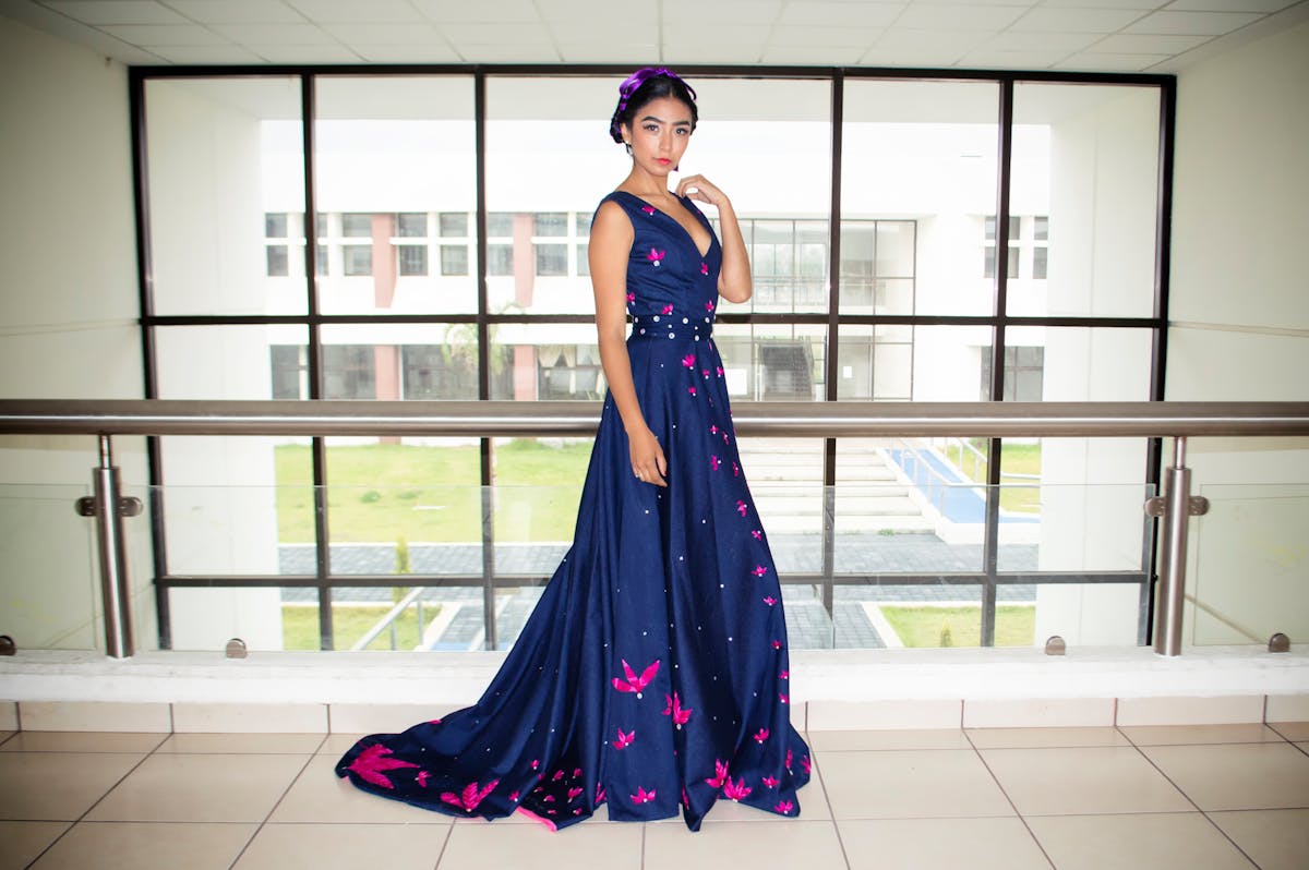 woman wearing blue floor length gown